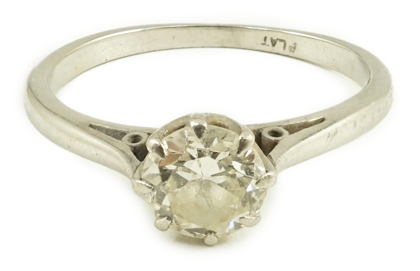 A white metal (stamped plat) and solitaire diamond set ring, size K, gross weight 2.6 grams